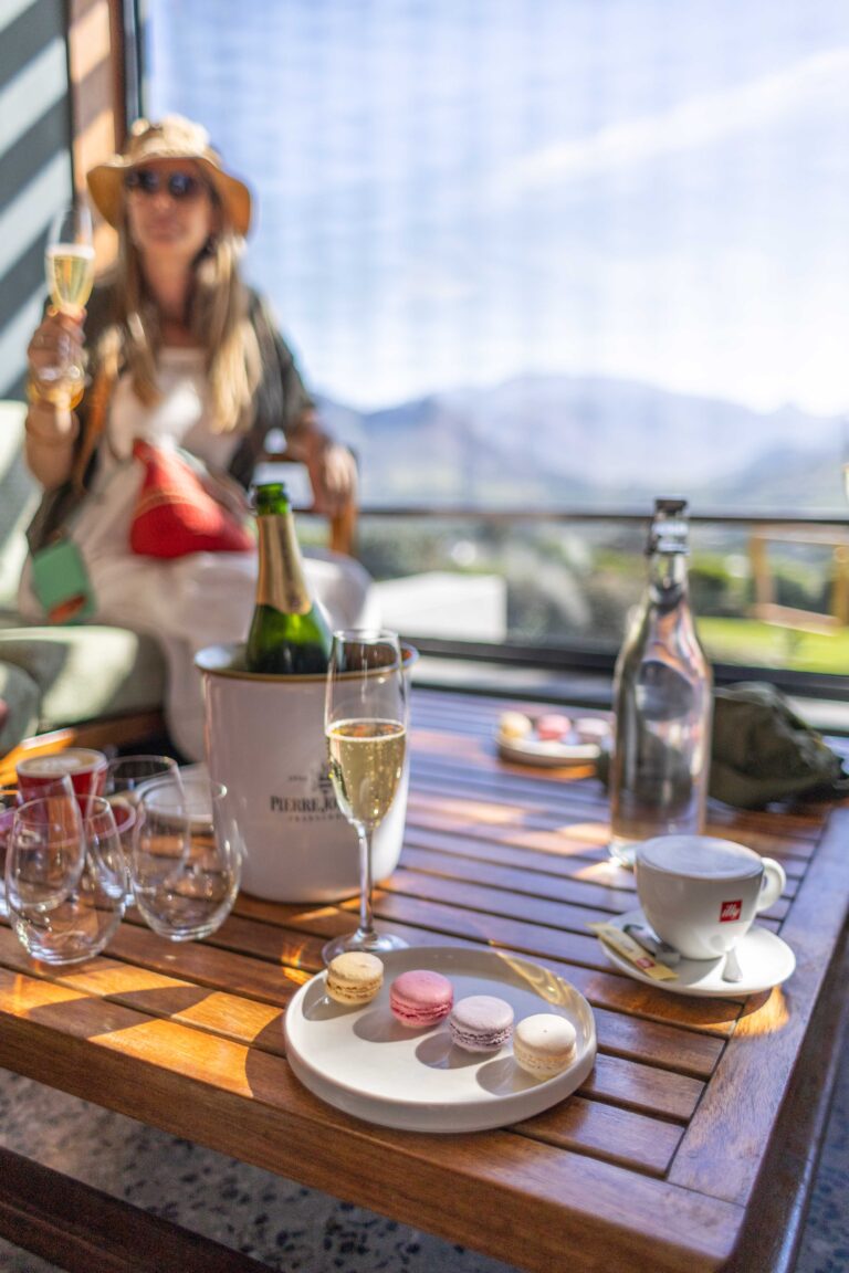 A guest raising a glass of bubbly at a Franschhoek tasting