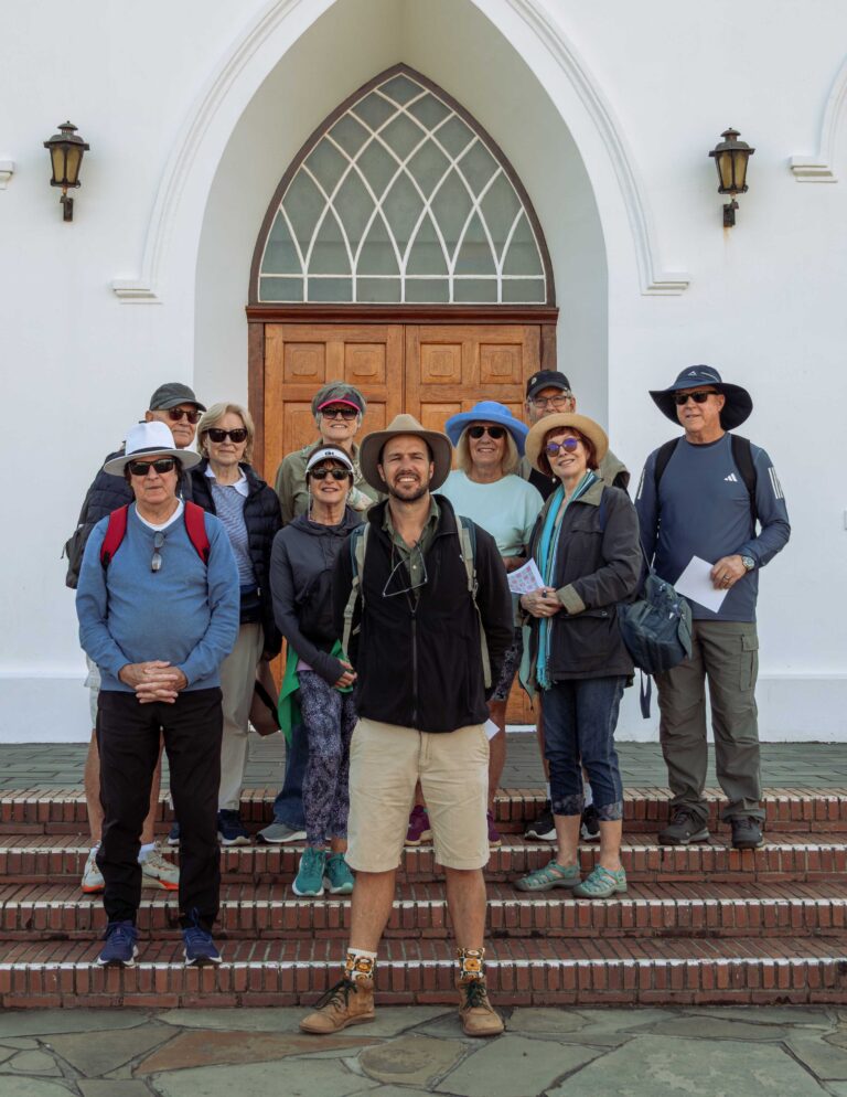 A Natural Wanders group in front of a historic church in Franschhoek